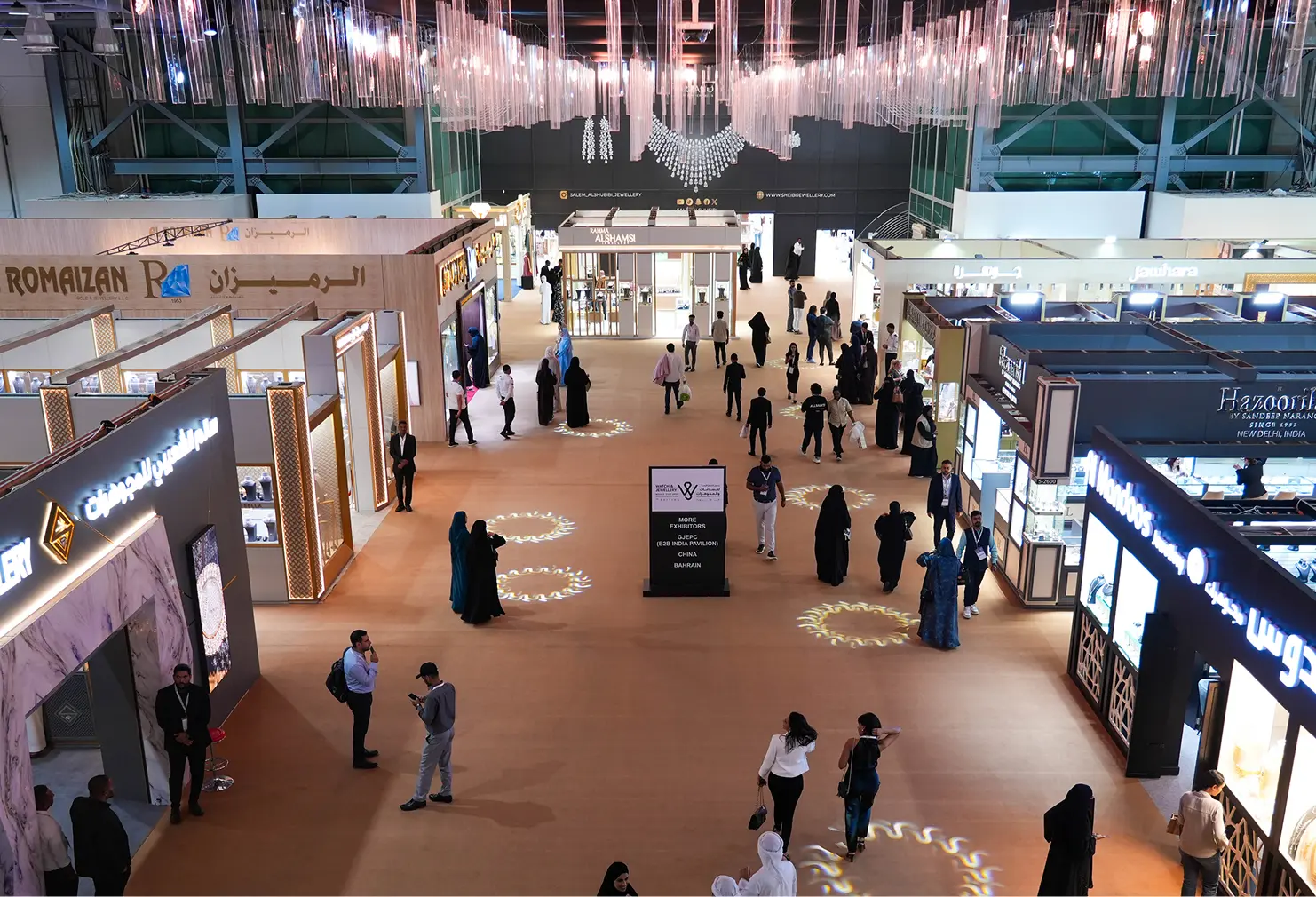 A large exhibition hall bustling with visitors walking around and engaging with different exhibits