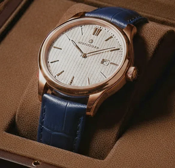 A stylish watch nestled in a brown box, complemented by blue leather straps